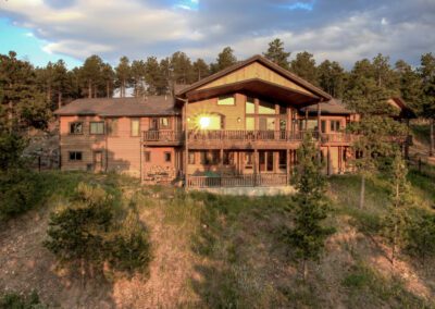 An aerial view of a large home on a hillside.