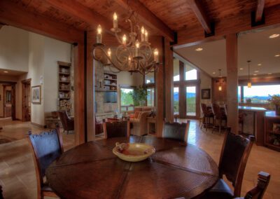 A dining room with a table and chairs.