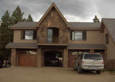 A house with a car parked in front of it.