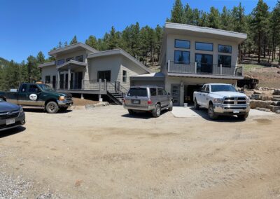 Two trucks parked in front of a house.