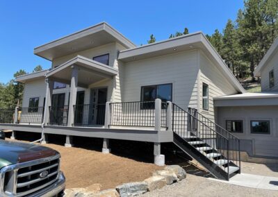 A home with stairs and a truck in front of it.