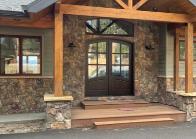 The front of a home with a stone porch.